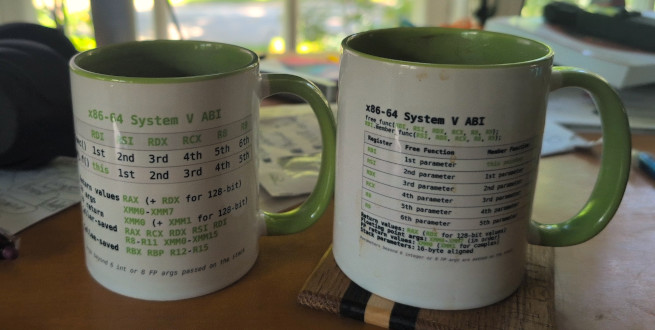 Some Compiler Explorer mugs with ABI information on them